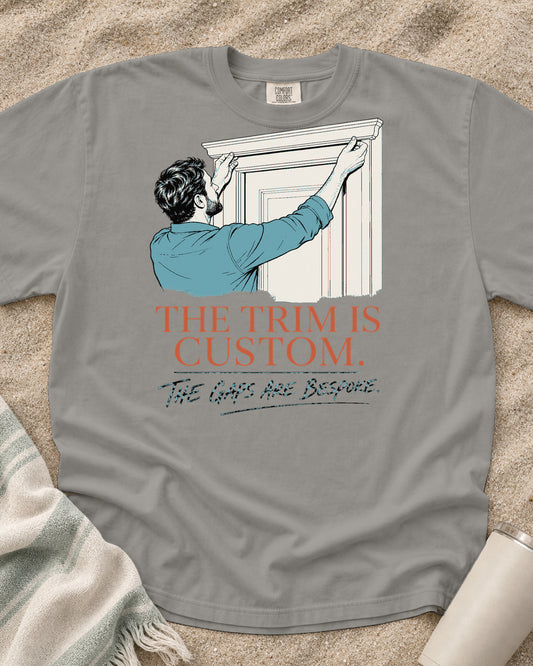 Grey Comfort Colors 1717 tee with The Trim Is Custom. The Gaps Are Bespoke graphic.
