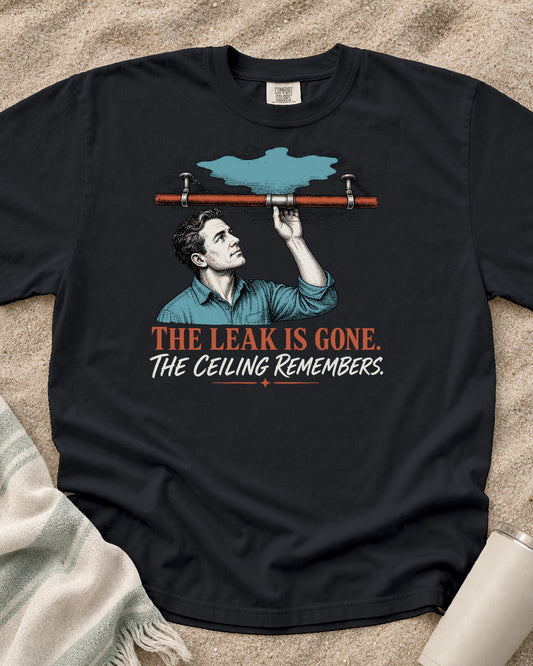 Graphite Comfort Colors 1717 tee with The Leak Is Gone. The Ceiling Remembers graphic.