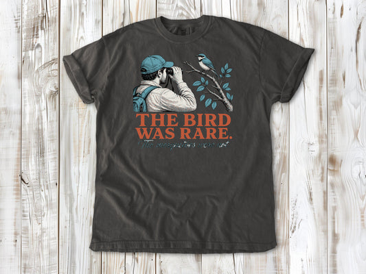 Ivory garment-dyed tee with The Bird Was Rare The Mosquitoes Were Not birdwatching graphic.