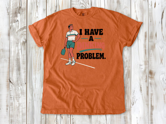 Seafoam garment-dyed tee with I Have a Dinking Problem pickleball graphic.