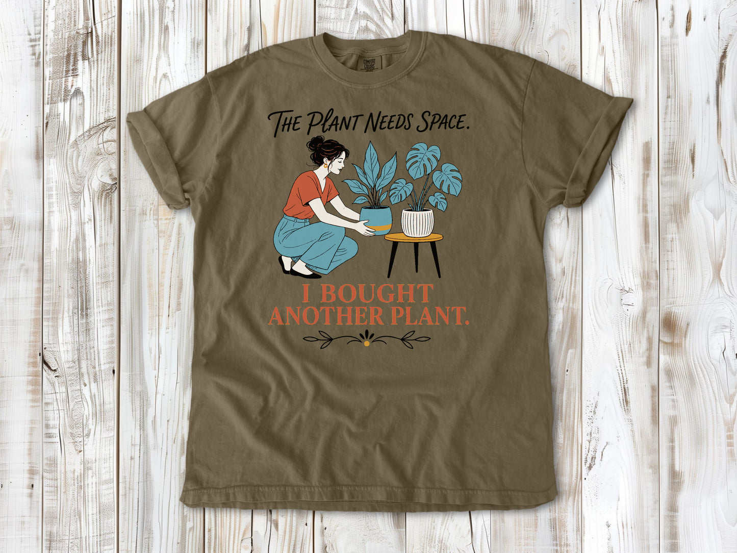 Graphite garment-dyed tee with The Plant Needs Space I Bought Another Plant houseplant graphic.