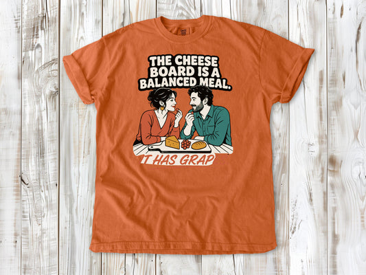 Seafoam garment-dyed tee with The Cheese Board Is a Balanced Meal It Has Grapes graphic.
