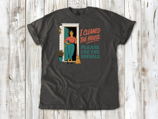 Ivory garment-dyed tee with I Cleaned the House Please Use the Sidewalk cleaning graphic.
