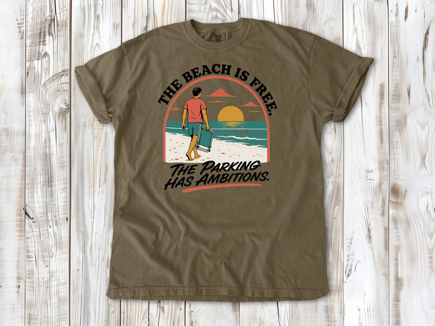 Graphite garment-dyed tee with The Beach Is Free The Parking Has Ambitions coastal graphic.