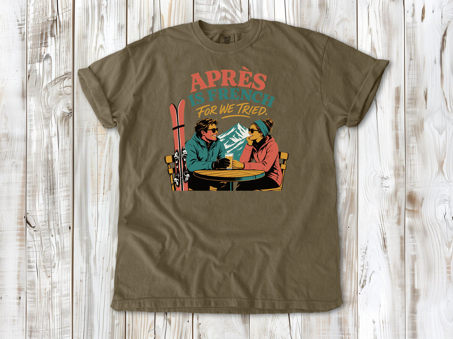 Graphite garment-dyed tee with Après Is French for We Tried skiing graphic.