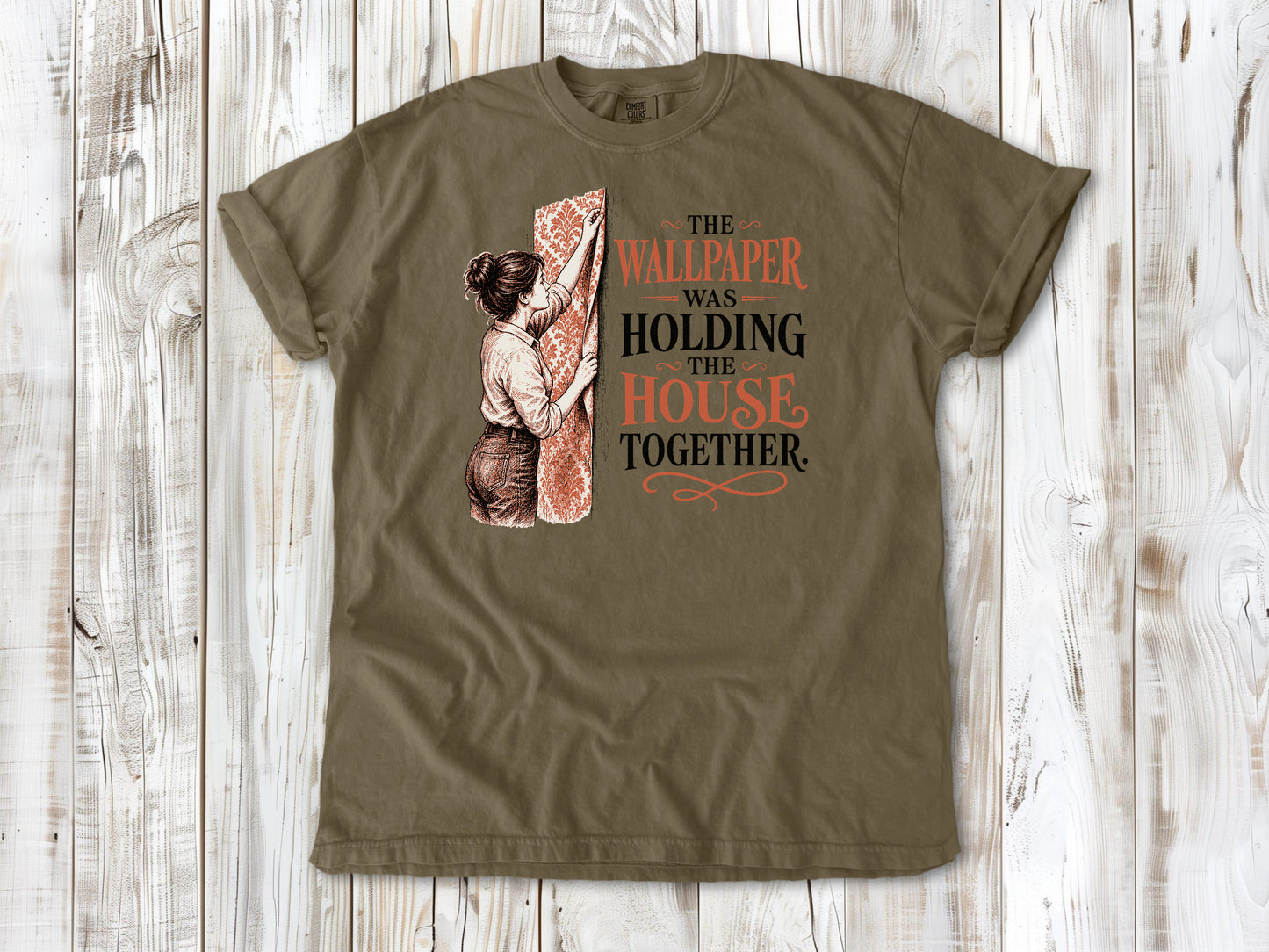 Graphite garment-dyed tee with The Wallpaper Was Holding the House Together renovation graphic.