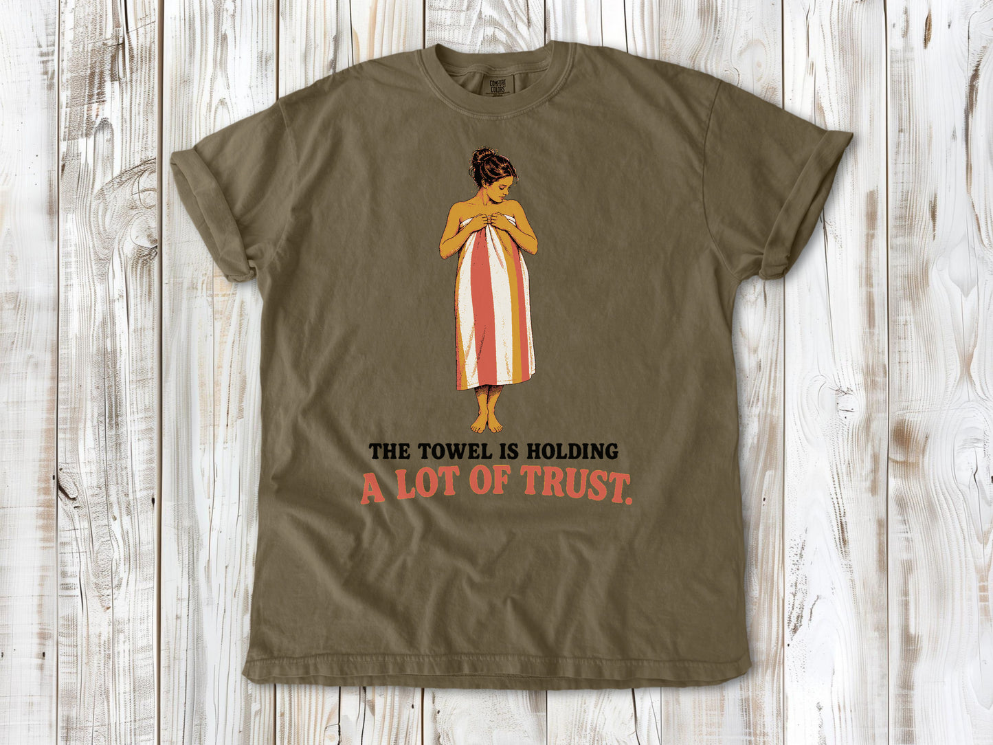 Graphite garment-dyed tee with The Towel Is Holding a Lot of Trust beach graphic.