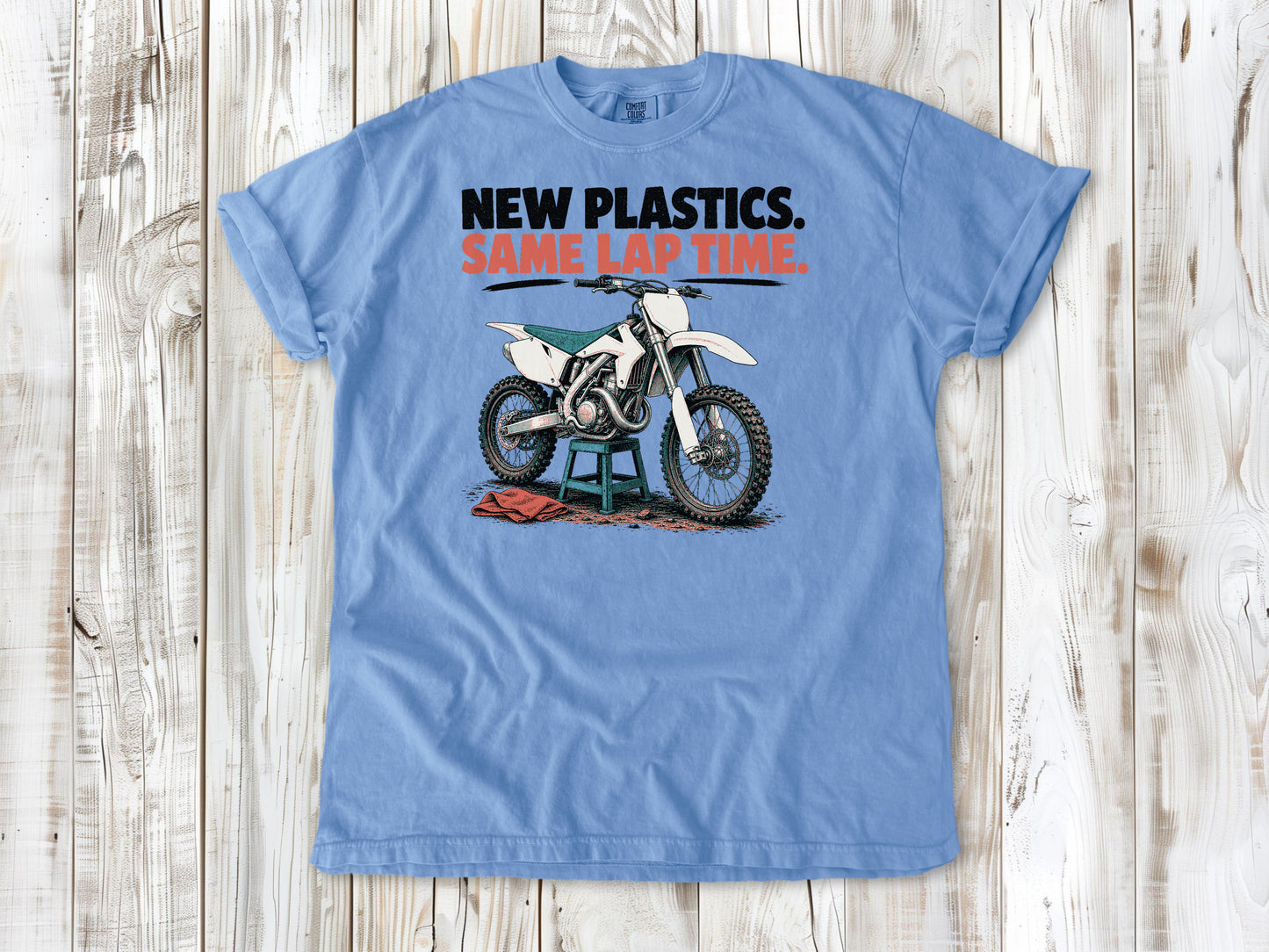 Washed Denim garment-dyed tee with New Plastics Same Lap Time dirt bike graphic.