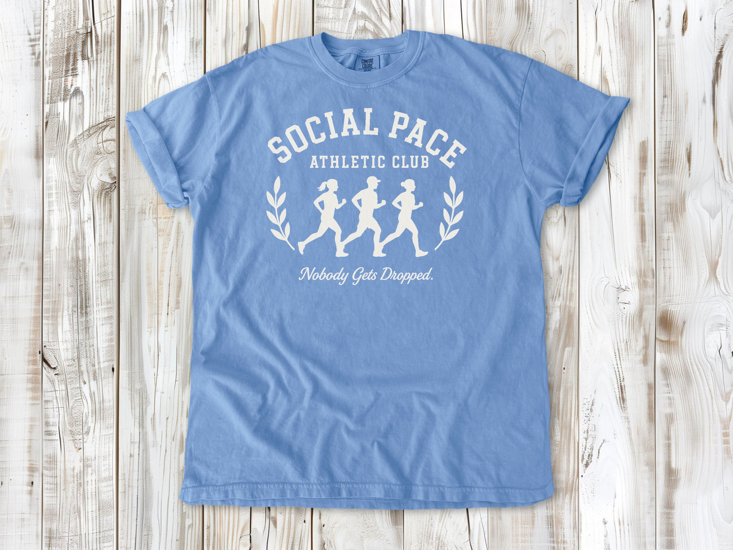 Washed Denim garment-dyed tee with Social Pace Athletic Club group running graphic.