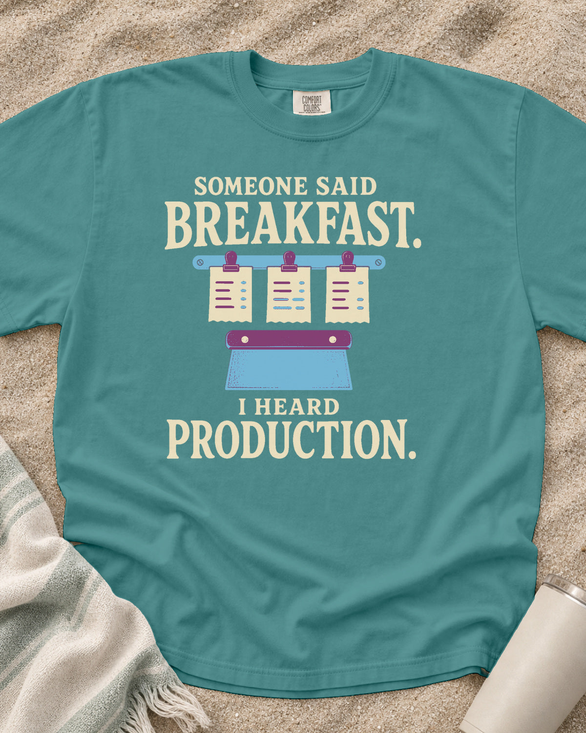 Seafoam garment-dyed tee with Someone Said Breakfast I Heard Production graphic.
