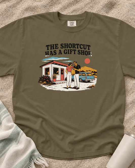 Khaki Comfort Colors 1717 tee with The Shortcut Has a Gift Shop graphic.