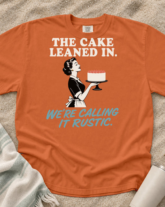 Burnt Orange Comfort Colors 1717 tee with The Cake Leaned In. We're Calling It Rustic graphic.