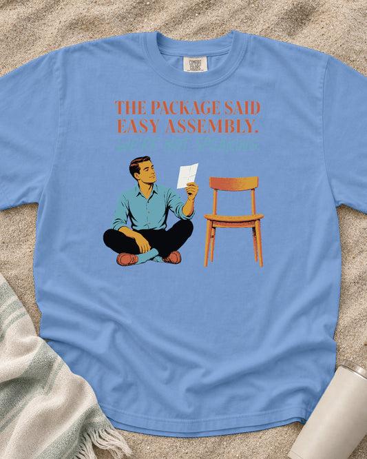Washed Denim Comfort Colors 1717 tee with The Package Said Easy Assembly. We're Not Speaking graphic.
