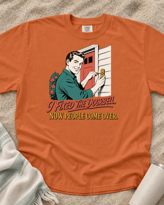Burnt Orange Comfort Colors 1717 tee with I Fixed the Doorbell. Now People Come Over graphic.