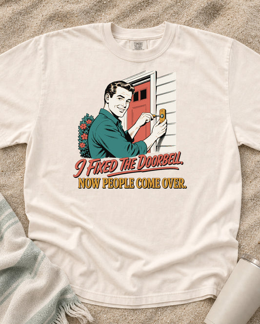 Ivory Comfort Colors 1717 tee with I Fixed the Doorbell. Now People Come Over graphic.