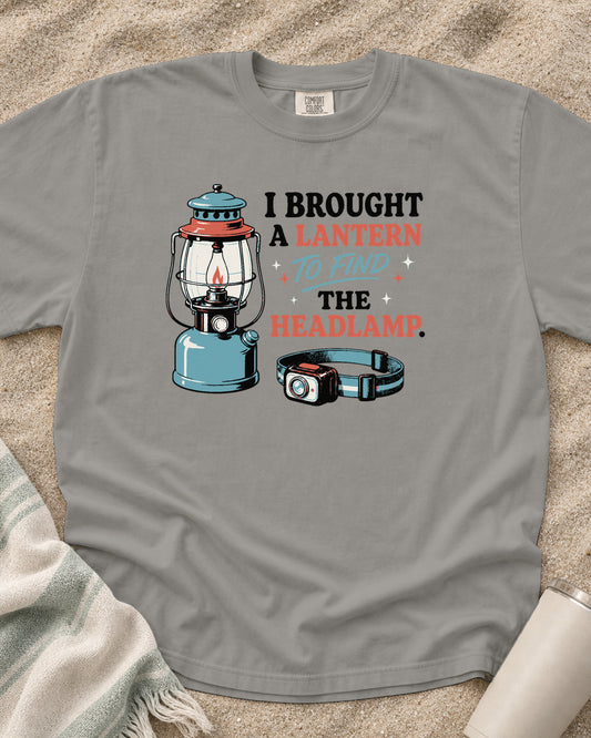 Grey Comfort Colors 1717 tee with A Lantern to Find the Headlamp graphic.