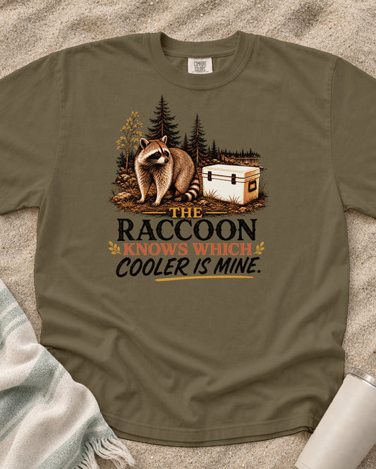 Khaki Comfort Colors 1717 tee with The Raccoon Knows My Cooler graphic.