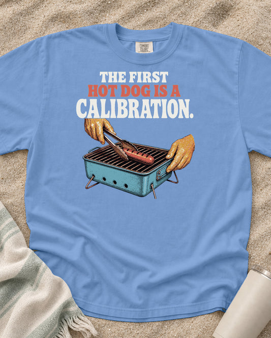 Washed Denim Comfort Colors 1717 tee with The First Hot Dog Is a Calibration graphic.