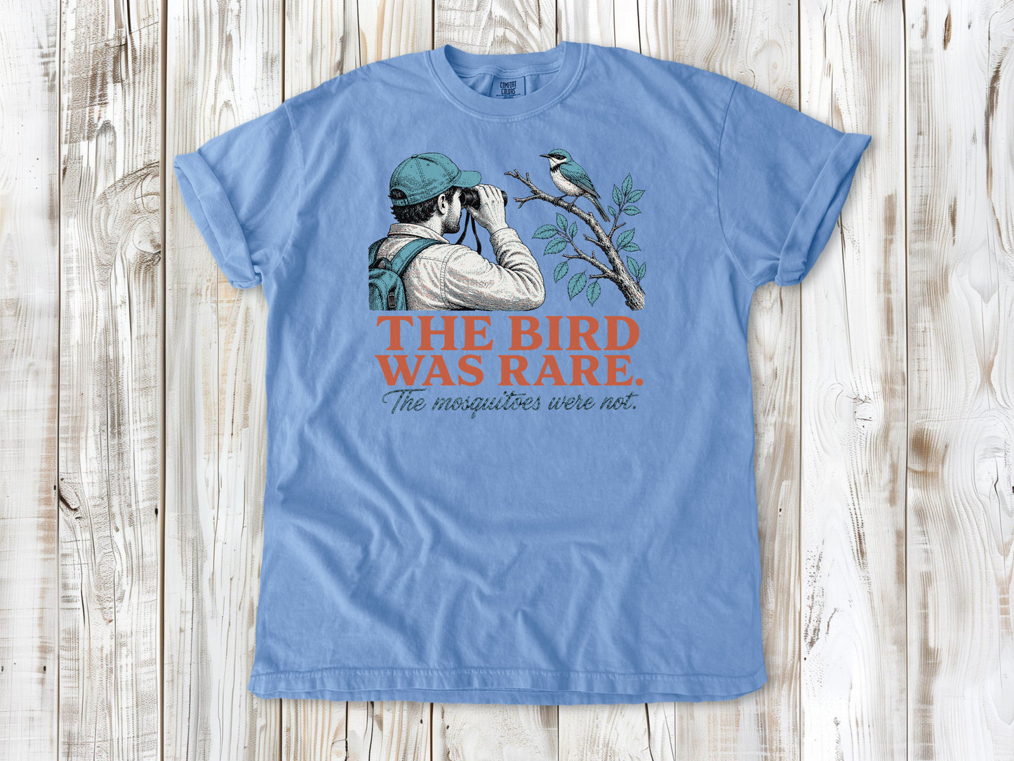 Pepper garment-dyed tee with The Bird Was Rare The Mosquitoes Were Not birdwatching graphic.