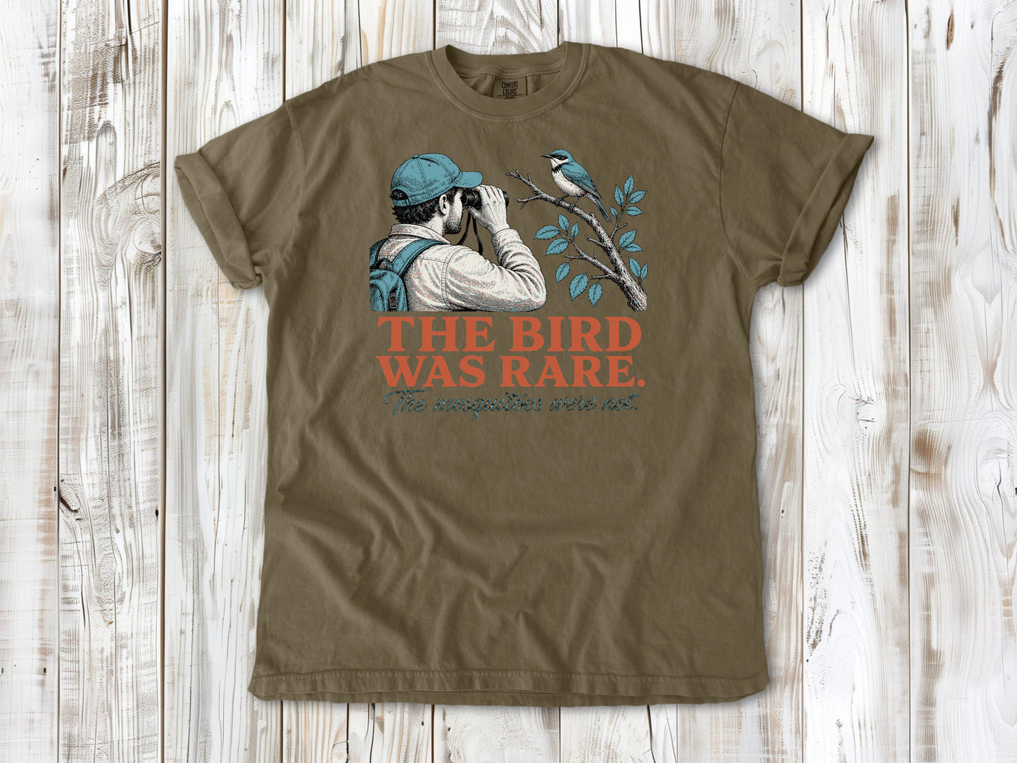 Graphite garment-dyed tee with The Bird Was Rare The Mosquitoes Were Not birdwatching graphic.