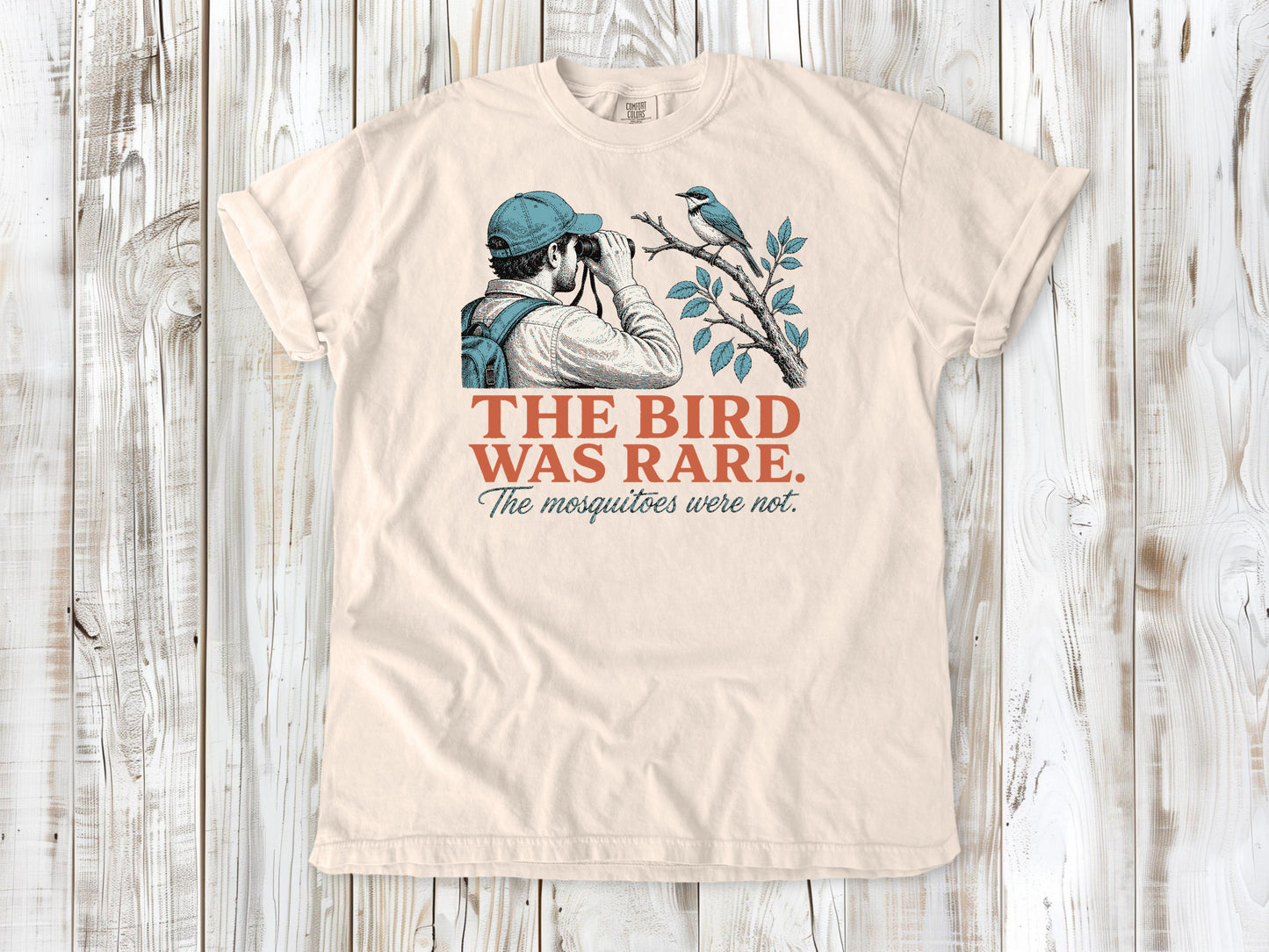 Butter garment-dyed tee with The Bird Was Rare The Mosquitoes Were Not birdwatching graphic.