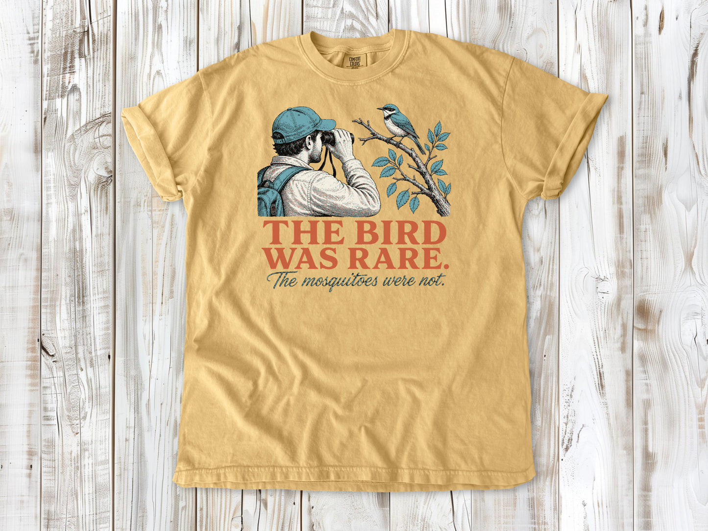 Burnt Orange garment-dyed tee with The Bird Was Rare The Mosquitoes Were Not birdwatching graphic.