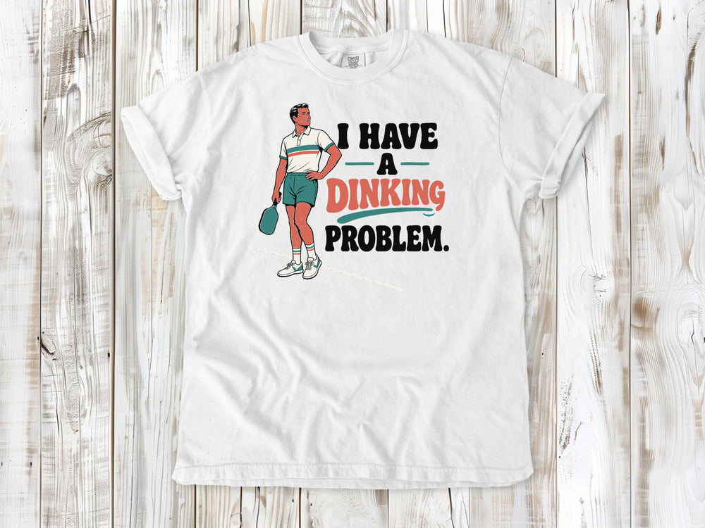 White garment-dyed tee with I Have a Dinking Problem pickleball graphic.