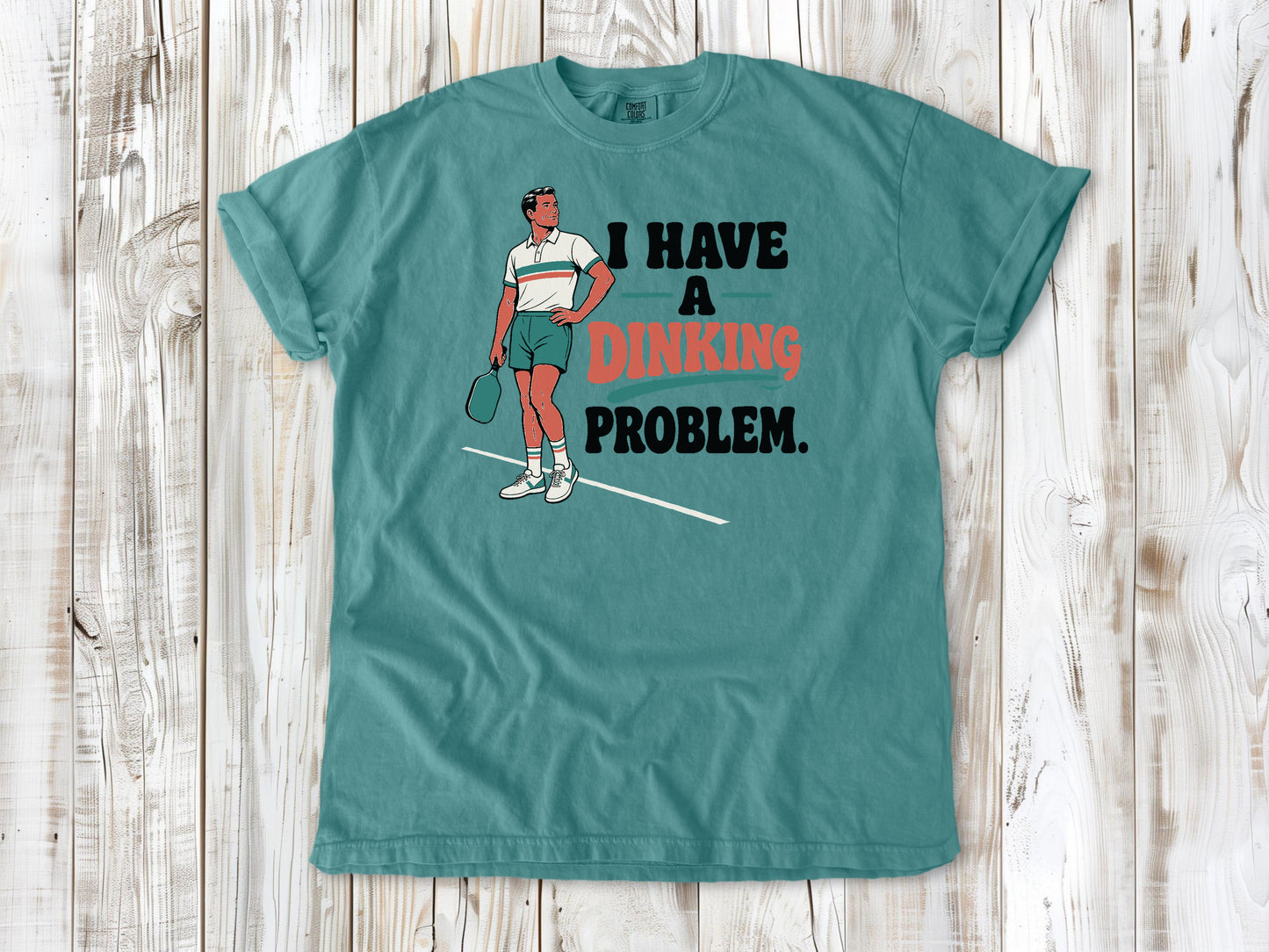 Mustard garment-dyed tee with I Have a Dinking Problem pickleball graphic.