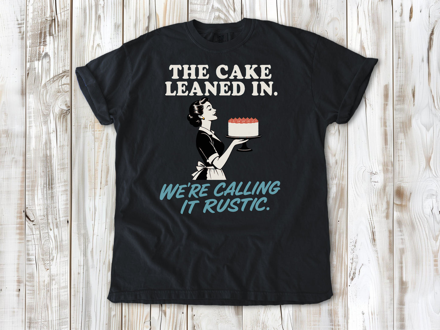 Washed Denim garment-dyed tee with The Cake Leaned In We're Calling It Rustic baking graphic.