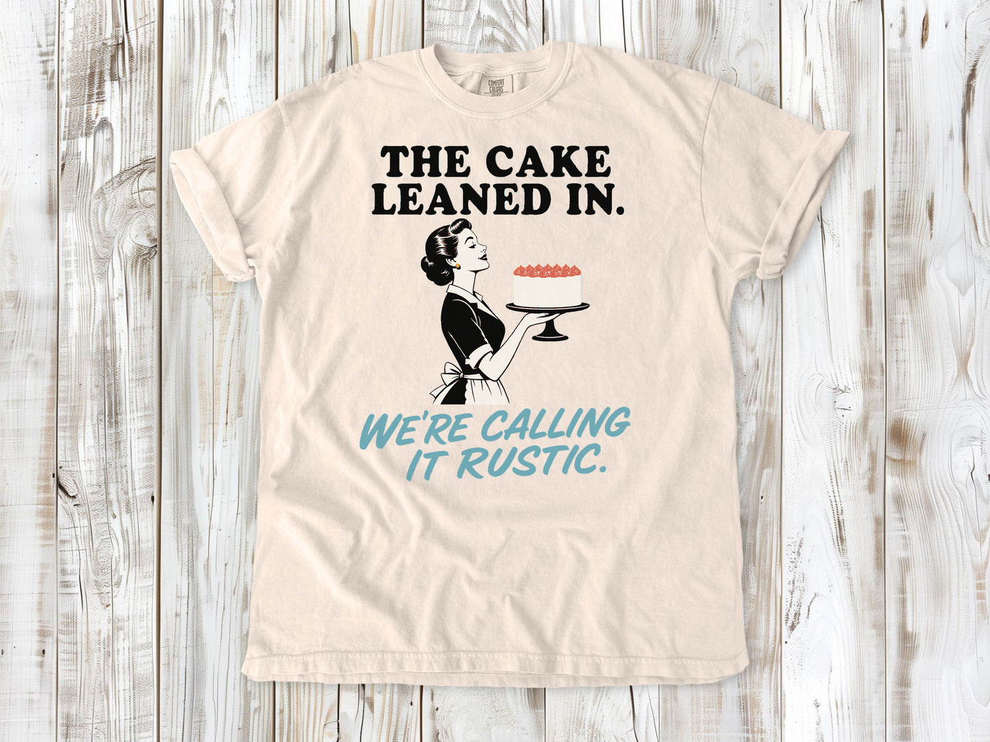 Butter garment-dyed tee with The Cake Leaned In We're Calling It Rustic baking graphic.