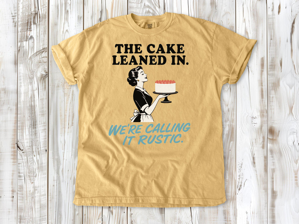 Burnt Orange garment-dyed tee with The Cake Leaned In We're Calling It Rustic baking graphic.