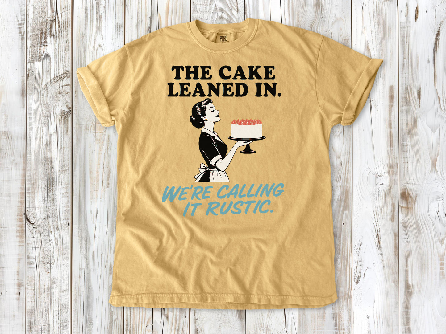 Burnt Orange garment-dyed tee with The Cake Leaned In We're Calling It Rustic baking graphic.