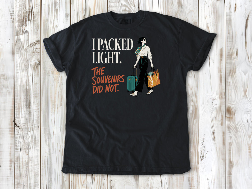 Washed Denim garment-dyed tee with I Packed Light The Souvenirs Did Not travel graphic.
