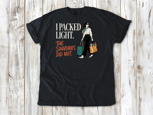 Washed Denim garment-dyed tee with I Packed Light The Souvenirs Did Not travel graphic.