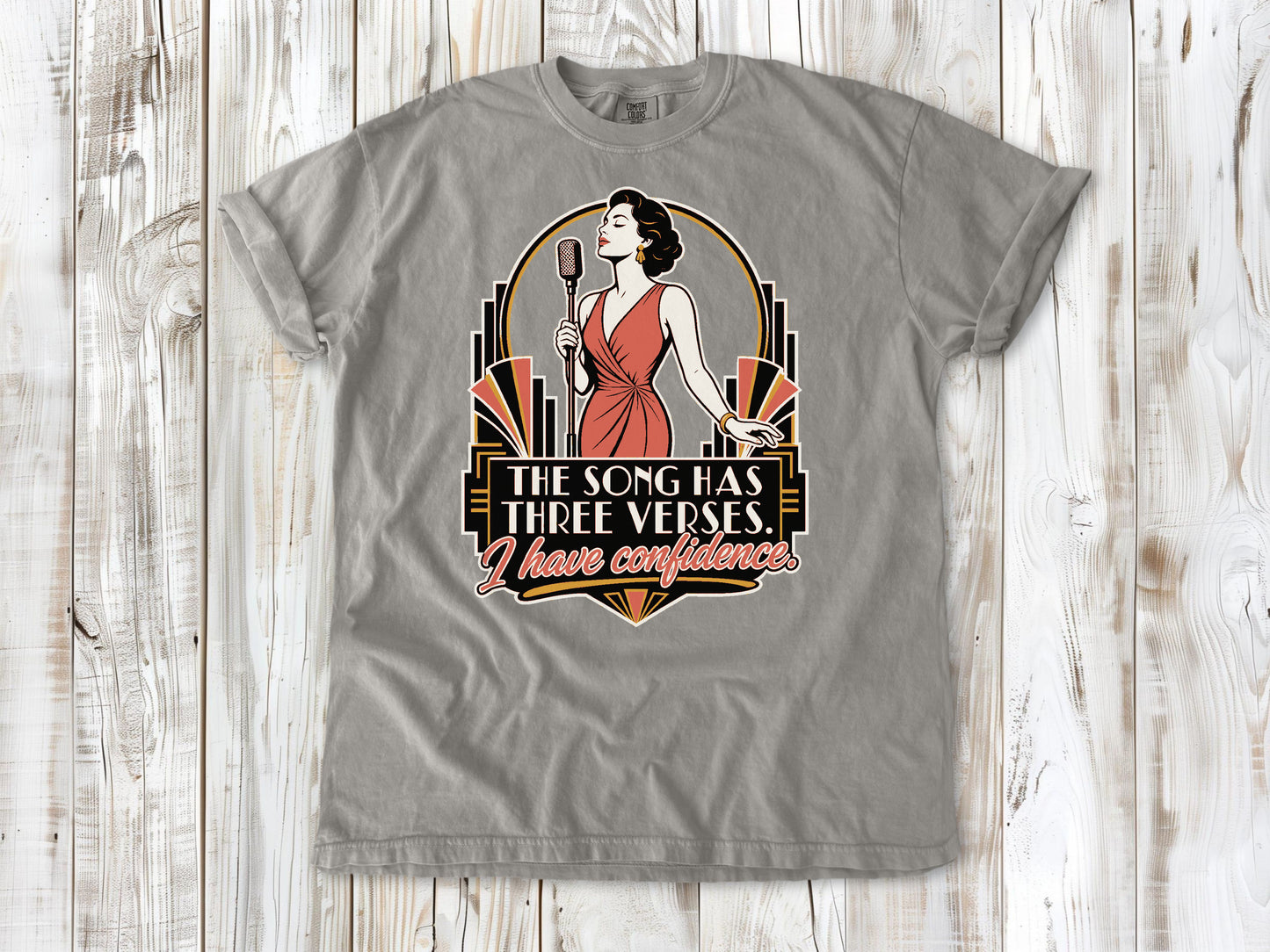 Khaki garment-dyed tee with The Song Has Three Verses I Have Confidence singing graphic.