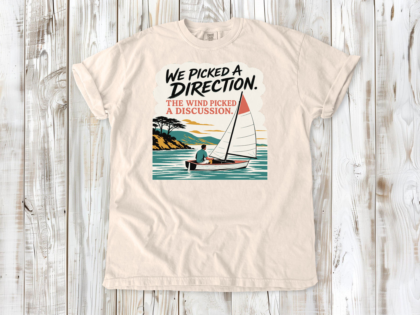 Butter garment-dyed tee with We Picked a Direction The Wind Picked a Discussion sailing graphic.