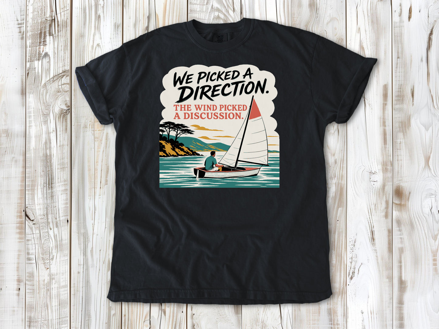 Washed Denim garment-dyed tee with We Picked a Direction The Wind Picked a Discussion sailing graphic.