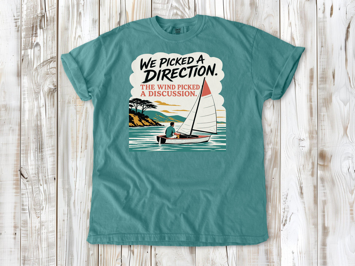 Mustard garment-dyed tee with We Picked a Direction The Wind Picked a Discussion sailing graphic.