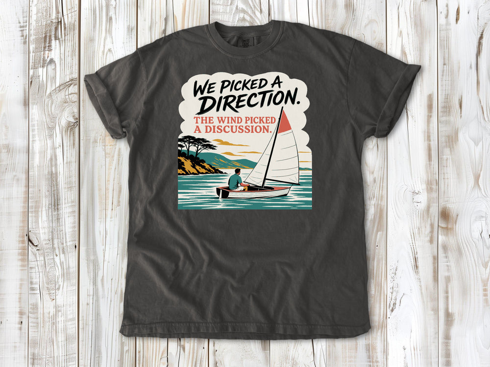 Ivory garment-dyed tee with We Picked a Direction The Wind Picked a Discussion sailing graphic.
