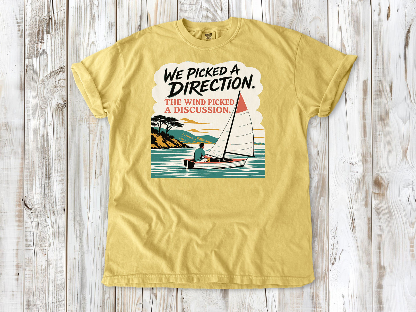 Grey garment-dyed tee with We Picked a Direction The Wind Picked a Discussion sailing graphic.