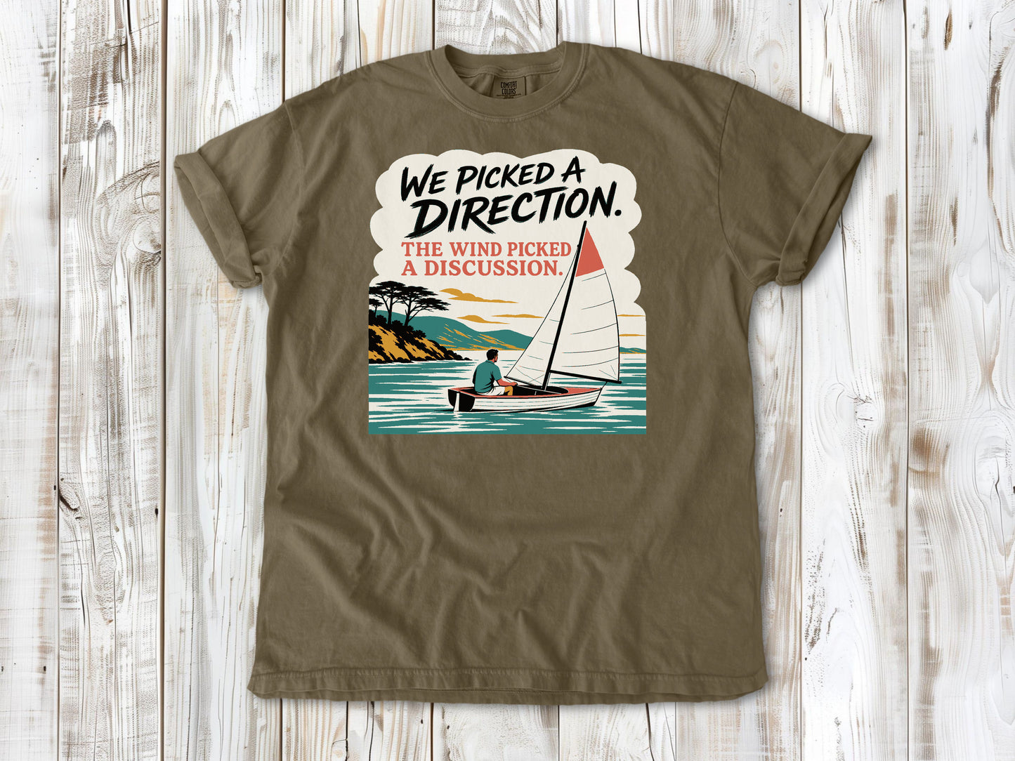 Graphite garment-dyed tee with We Picked a Direction The Wind Picked a Discussion sailing graphic.