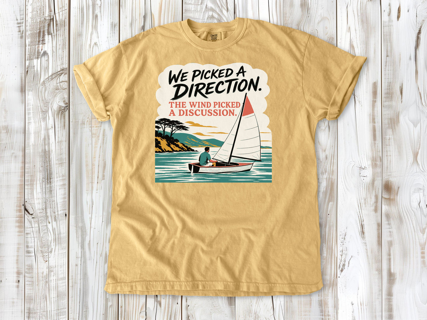 Burnt Orange garment-dyed tee with We Picked a Direction The Wind Picked a Discussion sailing graphic.