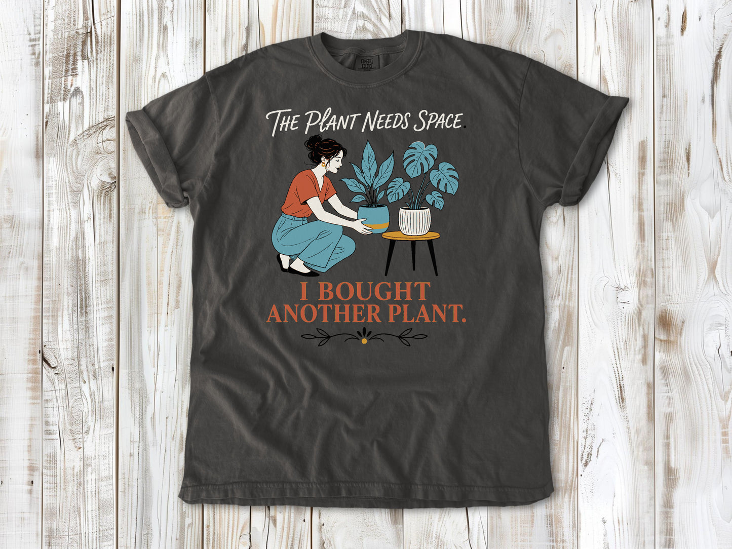 Ivory garment-dyed tee with The Plant Needs Space I Bought Another Plant houseplant graphic.