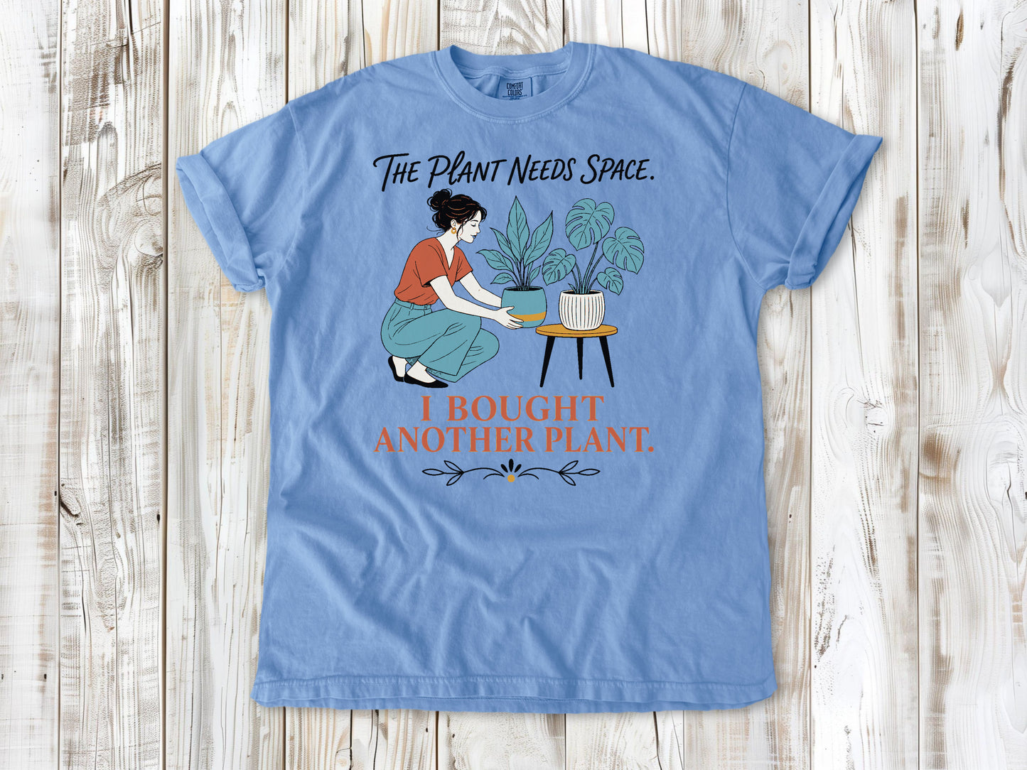 Pepper garment-dyed tee with The Plant Needs Space I Bought Another Plant houseplant graphic.
