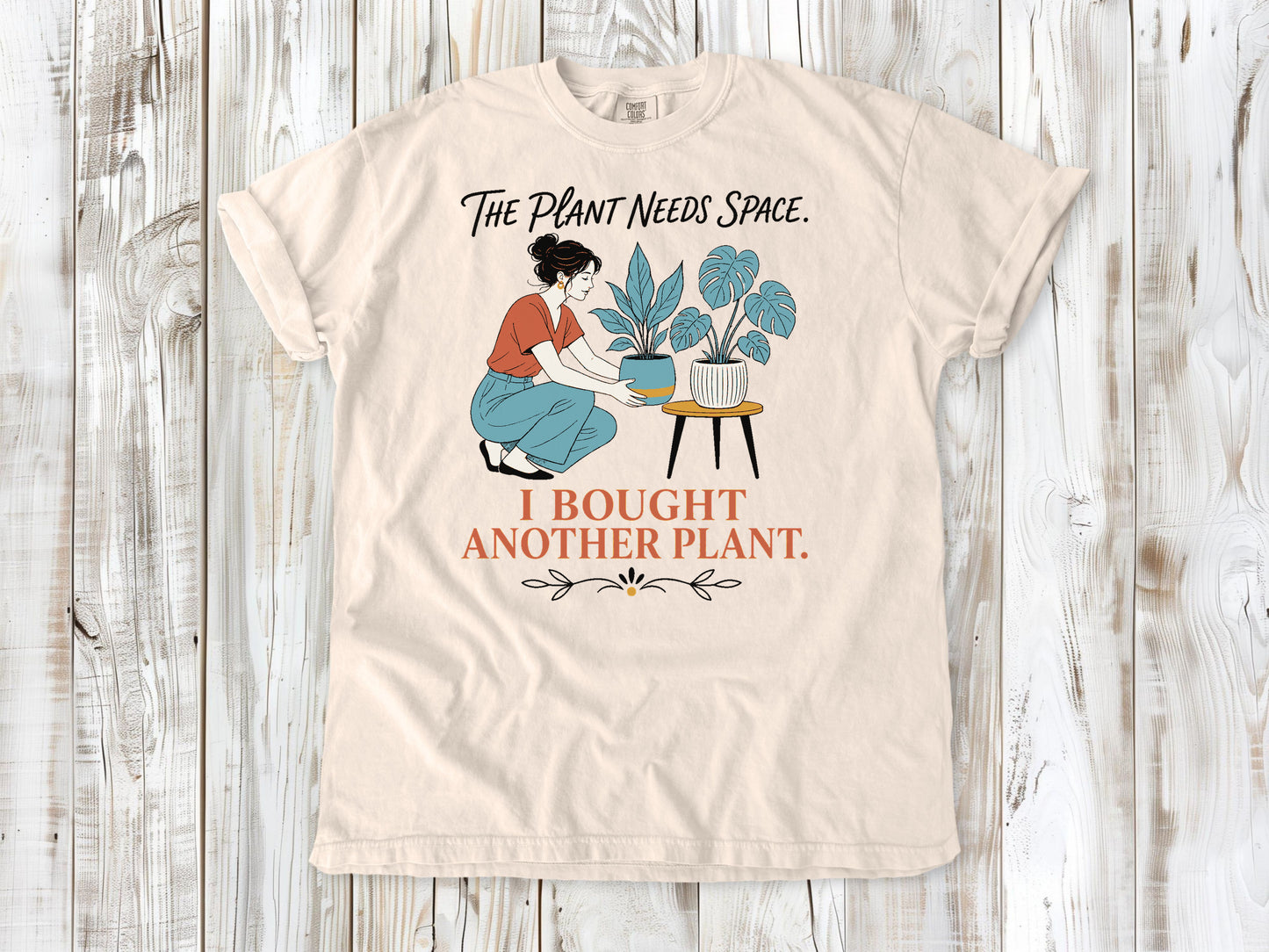Butter garment-dyed tee with The Plant Needs Space I Bought Another Plant houseplant graphic.