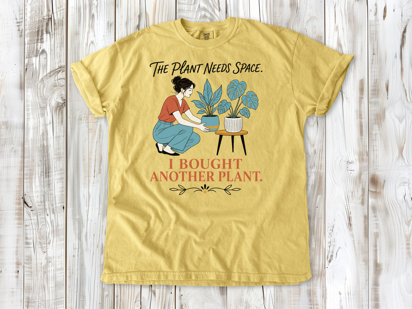 Grey garment-dyed tee with The Plant Needs Space I Bought Another Plant houseplant graphic.