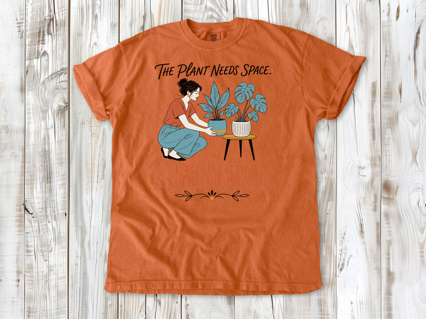 Seafoam garment-dyed tee with The Plant Needs Space I Bought Another Plant houseplant graphic.