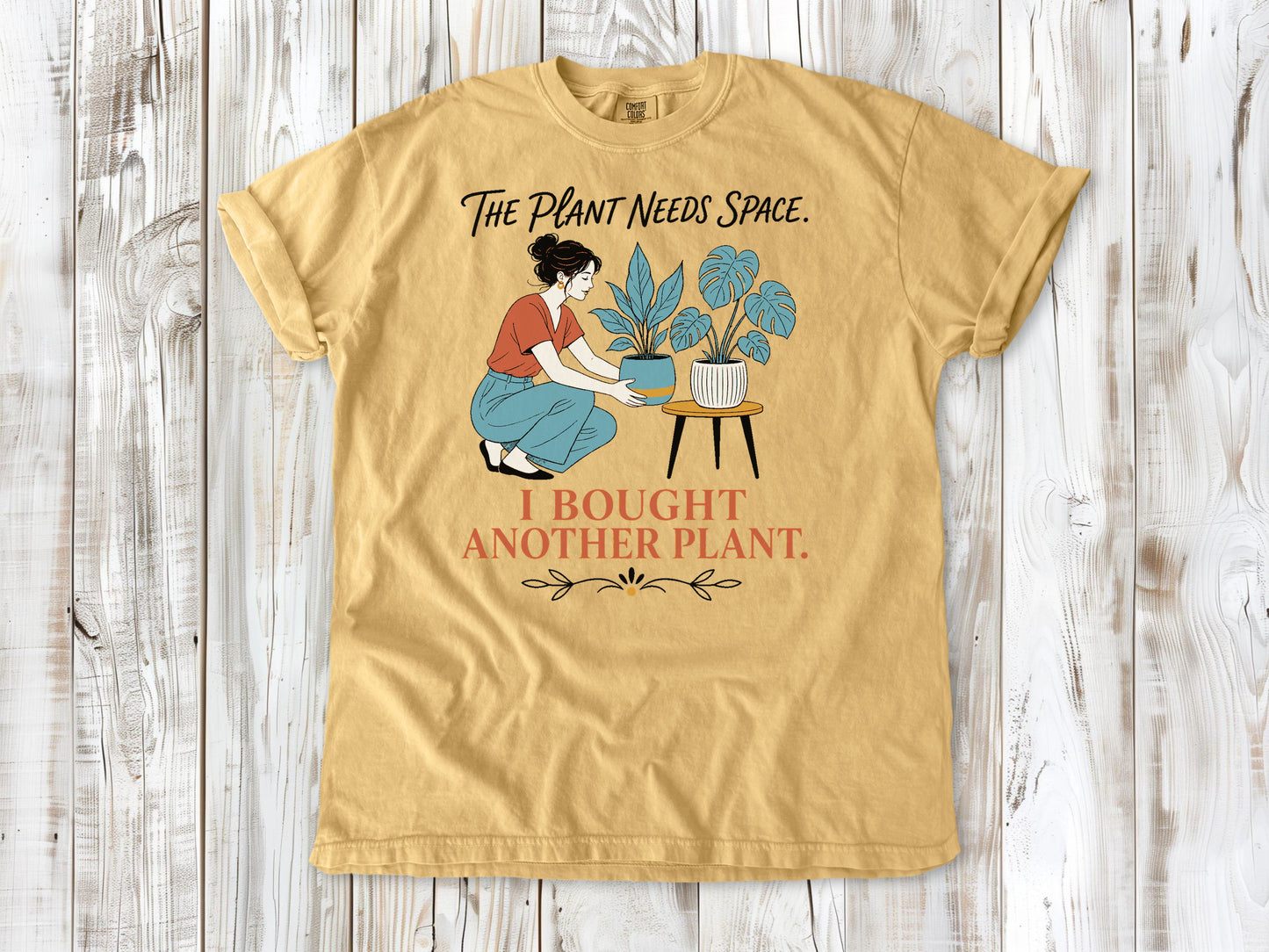 Burnt Orange garment-dyed tee with The Plant Needs Space I Bought Another Plant houseplant graphic.