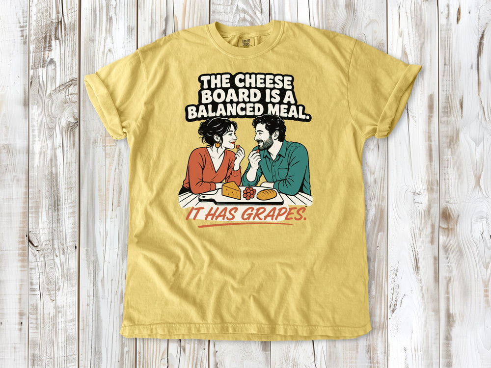 Grey garment-dyed tee with The Cheese Board Is a Balanced Meal It Has Grapes graphic.