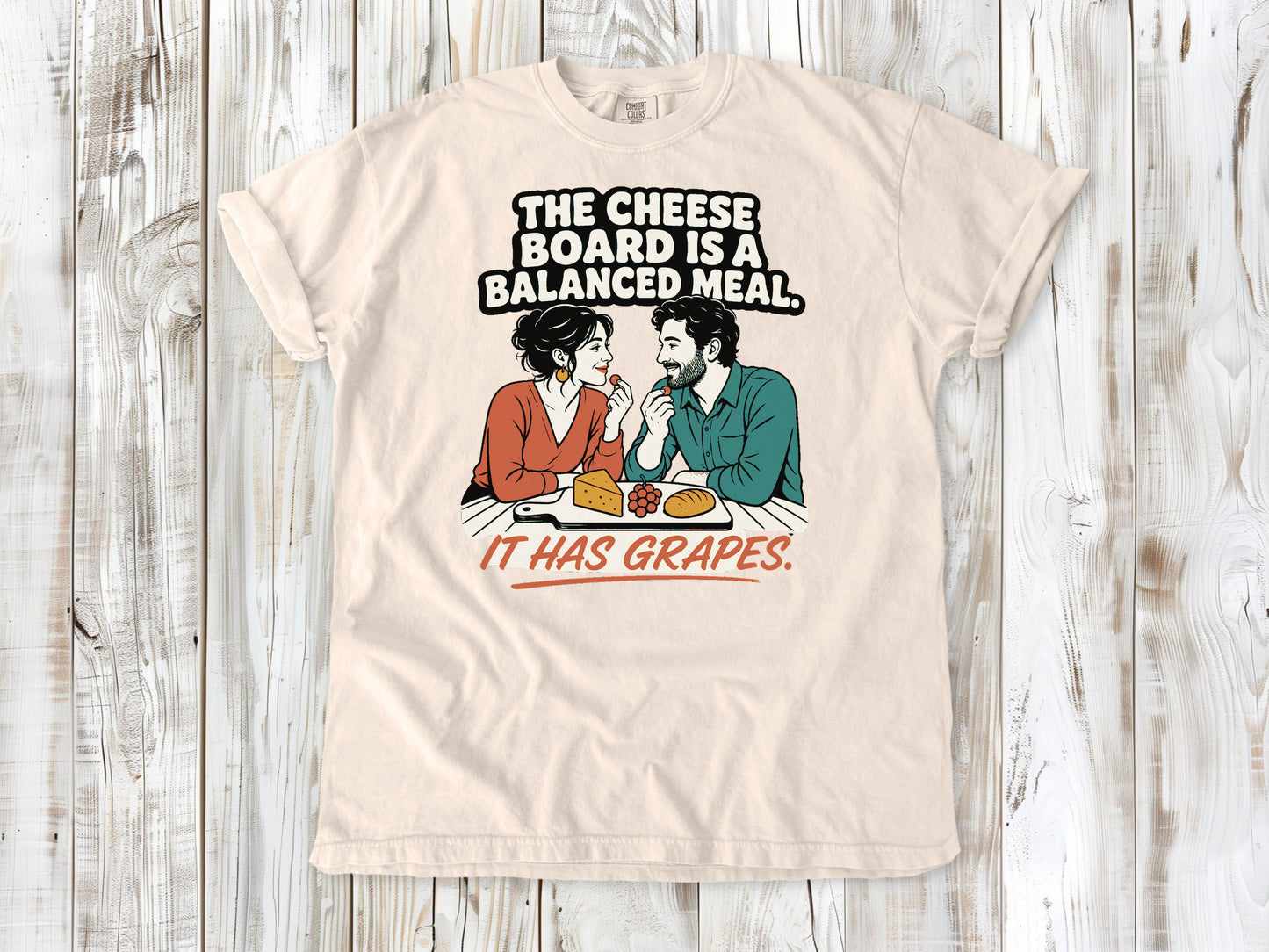 Butter garment-dyed tee with The Cheese Board Is a Balanced Meal It Has Grapes graphic.